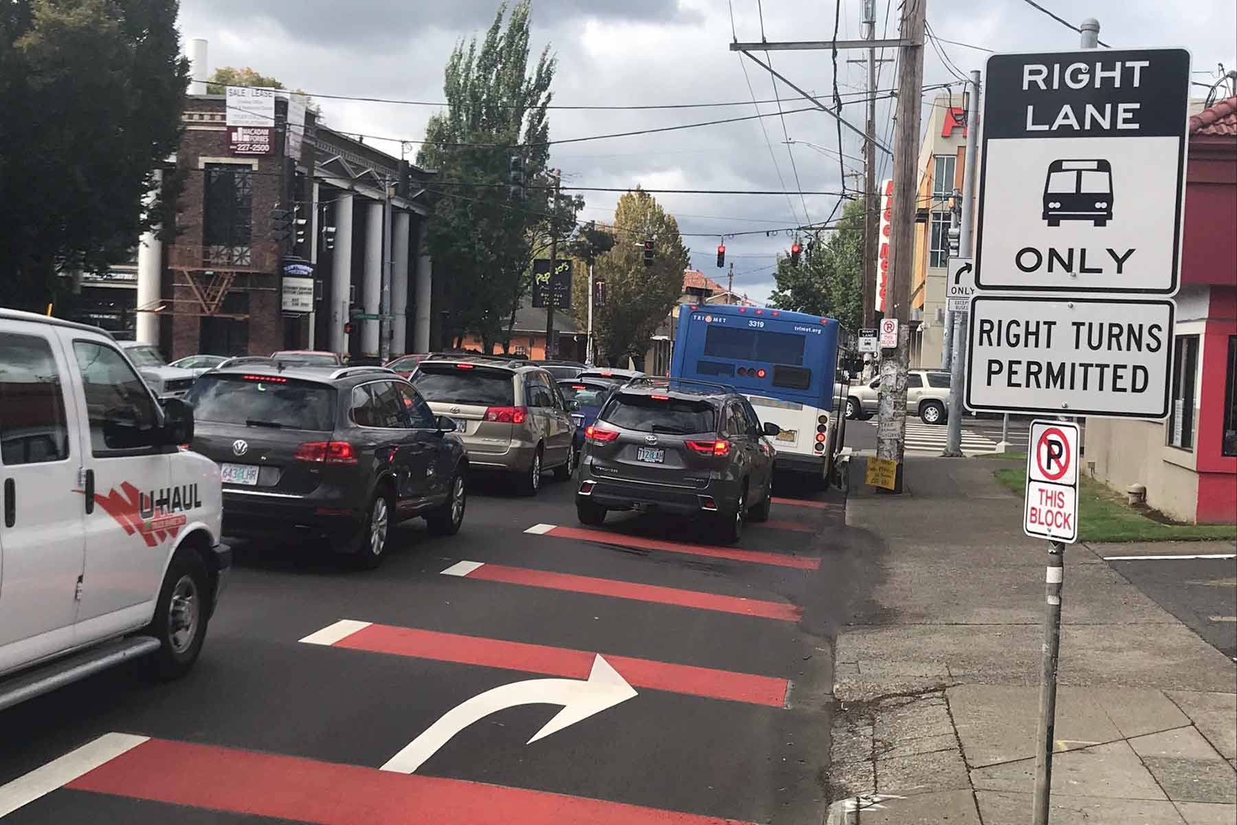 BAT lane with red lines and a sign that reads right lane bus only