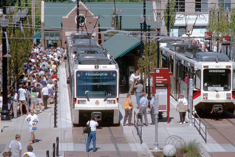 Opening day of Westside MAX service in Hillsboro with whtite Type 1 MAX trains at the platform