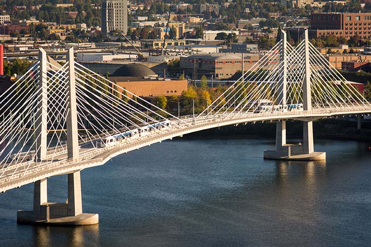 MAX Orange Line trains on the Tilikum Crossing headed in east & west directions